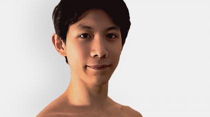 Male dancer with dark hair looking straight at the camera smiling