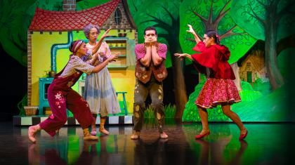 Little Red's family: father, mother, grandmother and Little Red act out the scary wolf to father who is quivering in fright