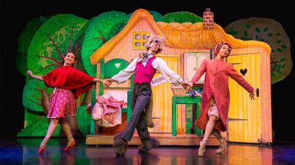 Little Red, her grand-mother and the wolf all dance together, happily and hand-in-hand