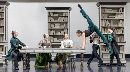 Around the dining table three sit and look on at Anne Lister whose lifting herself off the ground in anger