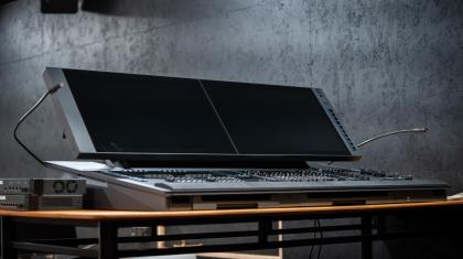 A new black lighting desk stood on a table with a grey background