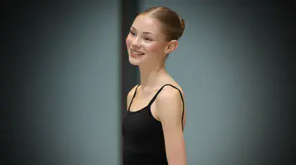 Woman in black wearing a black leotard