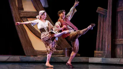 Cinderella in rags and her friend Jack dancing happily together